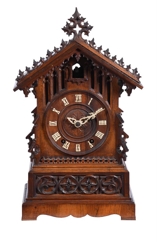 A carved oak and pine mantel clock of Black Forest type