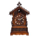 A carved oak and pine mantel clock of Black Forest type