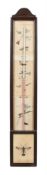 A stained wood cased wall thermometer