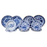 An assortment of mostly Dutch Delft blue and white plates and chargers