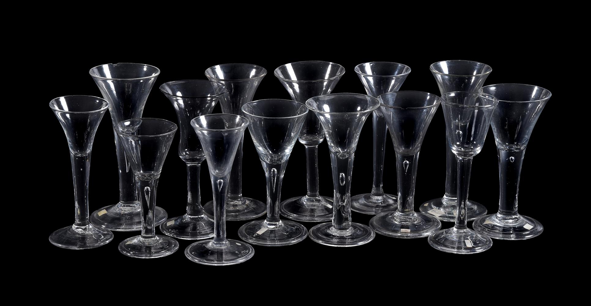 Fourteen various plain-stemmed wine glasses