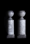 A pair of blue tarquin marble urns-on-plinths