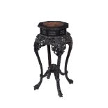 A Chinese carved hardwood and marble inset jardiniere stand