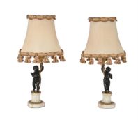 A pair of French patinated and parcel gilt bronze and marble mounted figural table lamps in Louis XV