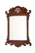 A mahogany and parcel gilt fret framed wall mirror in George III style