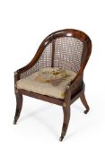A Regency stained beech and gilt metal mounted bergere armchair
