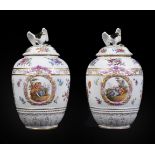 A pair of German porcelain Berlin style vases and covers with eagle finials