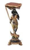 An ebonised, gilt and polychrome painted carved wood Blackamoor torchere stand