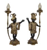 A pair of patinated and parcel gilt metal blackamoor figural torcheres