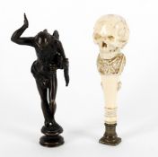 Y A late 19th century finely carved ivory seal as a skull above wine and grape decorated stem