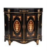 An ebonised and inlaid gilt metal mounted serpentine side cabinet,