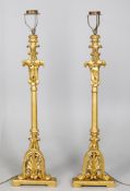 A pair of carved giltwood standard lamps