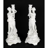 A pair of white glaze Continental candlesticks or candelabra bases