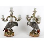 A pair of late German four branch 'parrot' candelabra