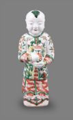 A good Chinese porcelain wucai standing figure of a boy holding a vase