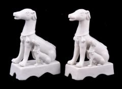 An attractive pair of Chinese porcelain Dehua models of wide-eyed seated hounds