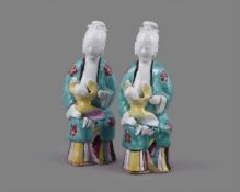 A pair of Chinese porcelain Famille Rose models of seated ladies