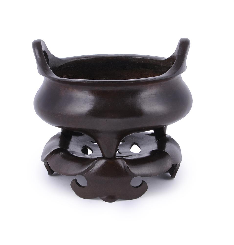 A large Chinese bronze circular incense burner and stand