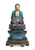 A Chinese blue and aubergine Fahua-glazed pottery figure of Buddha