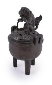 A Chinese bronze tripod censer and cover