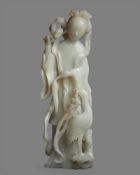 A large Chinese white jade figure of Guan Yin