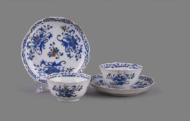 A pair of Chinese porcelain blue enamel decorated hexagonal lobed tea bowls and saucers