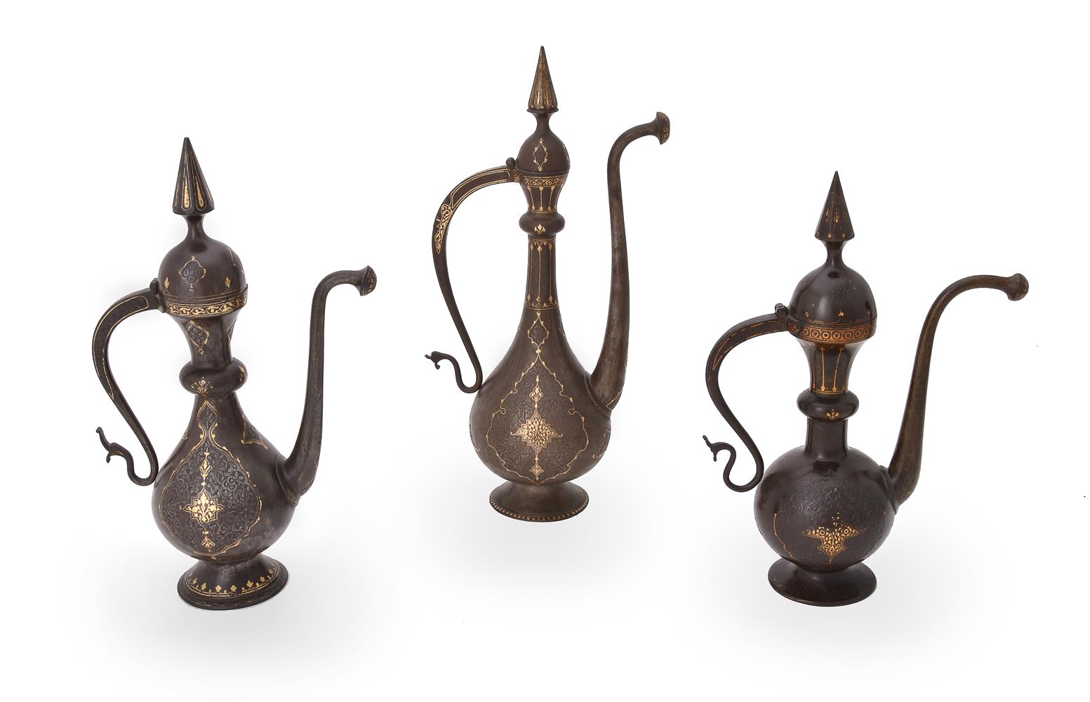 Three Qajar damascened and engraved steel ewers