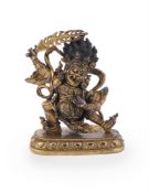A Sino-Tibetan gilt bronze figure of a Dharmapala