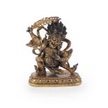 A Sino-Tibetan gilt bronze figure of a Dharmapala