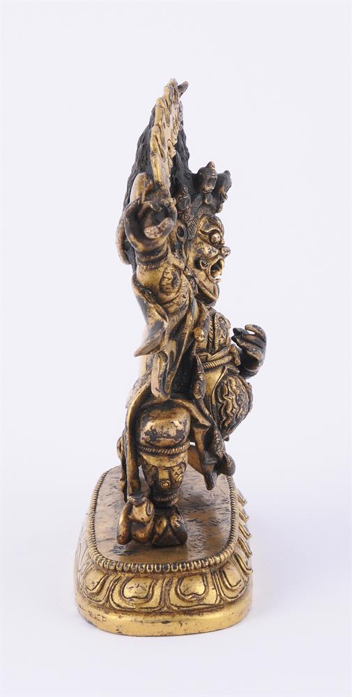 A Sino-Tibetan gilt bronze figure of a Dharmapala - Image 2 of 5