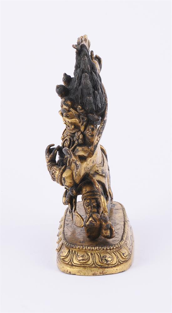 A Sino-Tibetan gilt bronze figure of a Dharmapala - Image 4 of 5