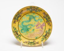 A Chinese yellow ground green and aubergine-enamelled 'Dragon and phoenix' dish