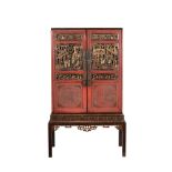 A Chinese red lacquered cabinet on stand