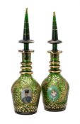 A green glass and gilt decanters with spire shaped stoppers