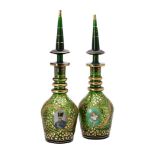 A green glass and gilt decanters with spire shaped stoppers