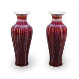 A pair of modern Asian porcelain sang du boeuf glazed baluster vases