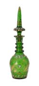 A green cut glass decanter and spier shaped stopper