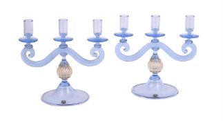 A pair of pale blue and gilt glass three branch candlesticks