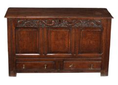 A carved oak mule chest