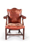 A George III mahogany and leather upholstered open armchair