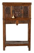 A carved oak cupboard on stand