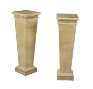 A pair of simulated grey painted display pedestals