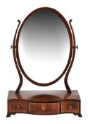 A George III mahogany and inlaid oval dressing mirror