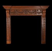 A carved and varnished pine chimney piece in George III style