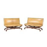 A pair of French carved oak and leather upholstered seats