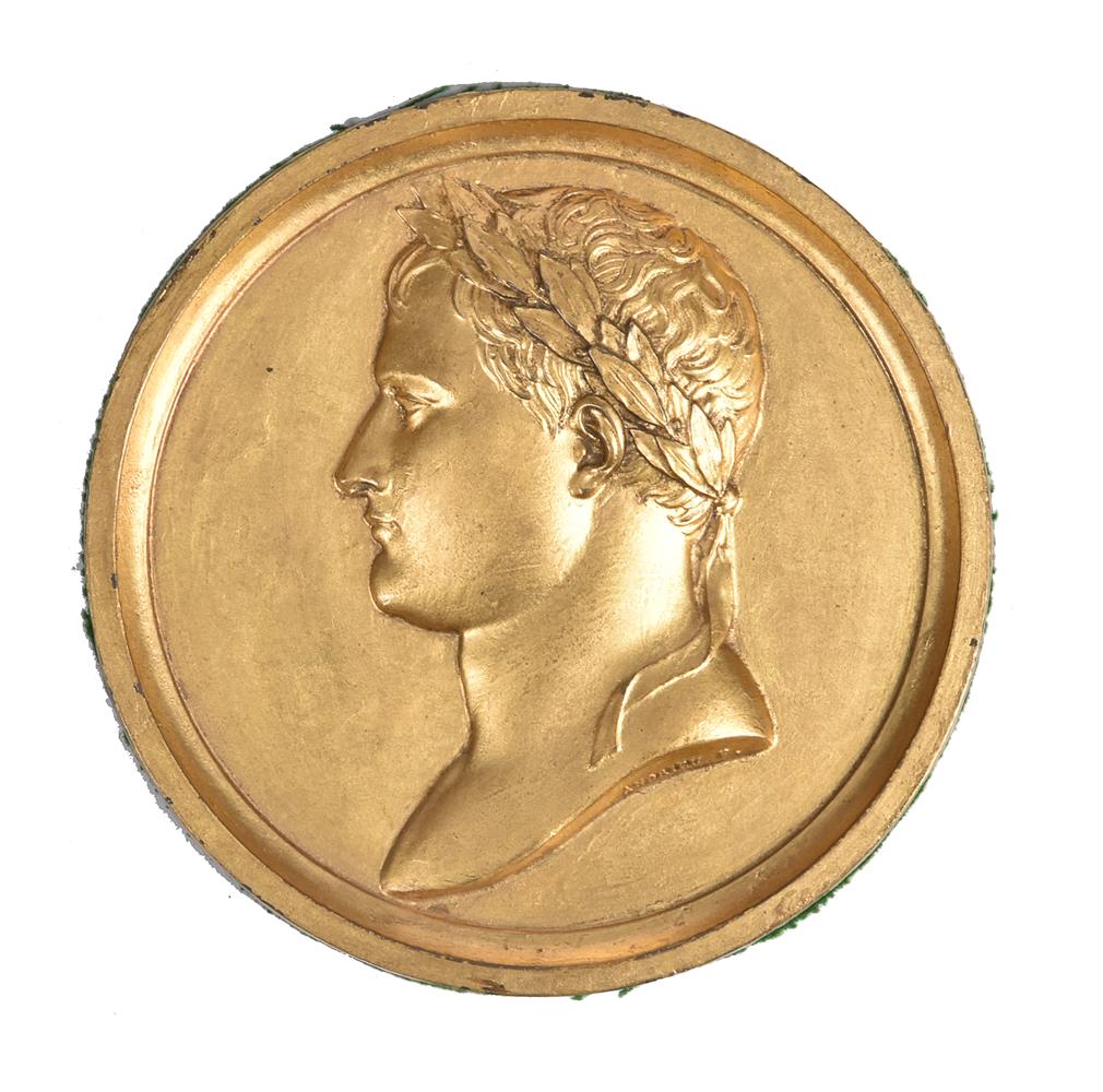 A signed and gilded lead medallion of Napoleon as Emperor. French