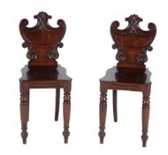 A pair of George IV mahogany hall chairs