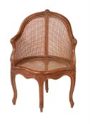 A carved beech and caned fauteuil de bureau in Louis XV style