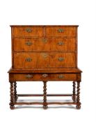 A walnut and line inlaid chest on stand