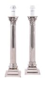 A pair of silver coloured metal columnar table lamps